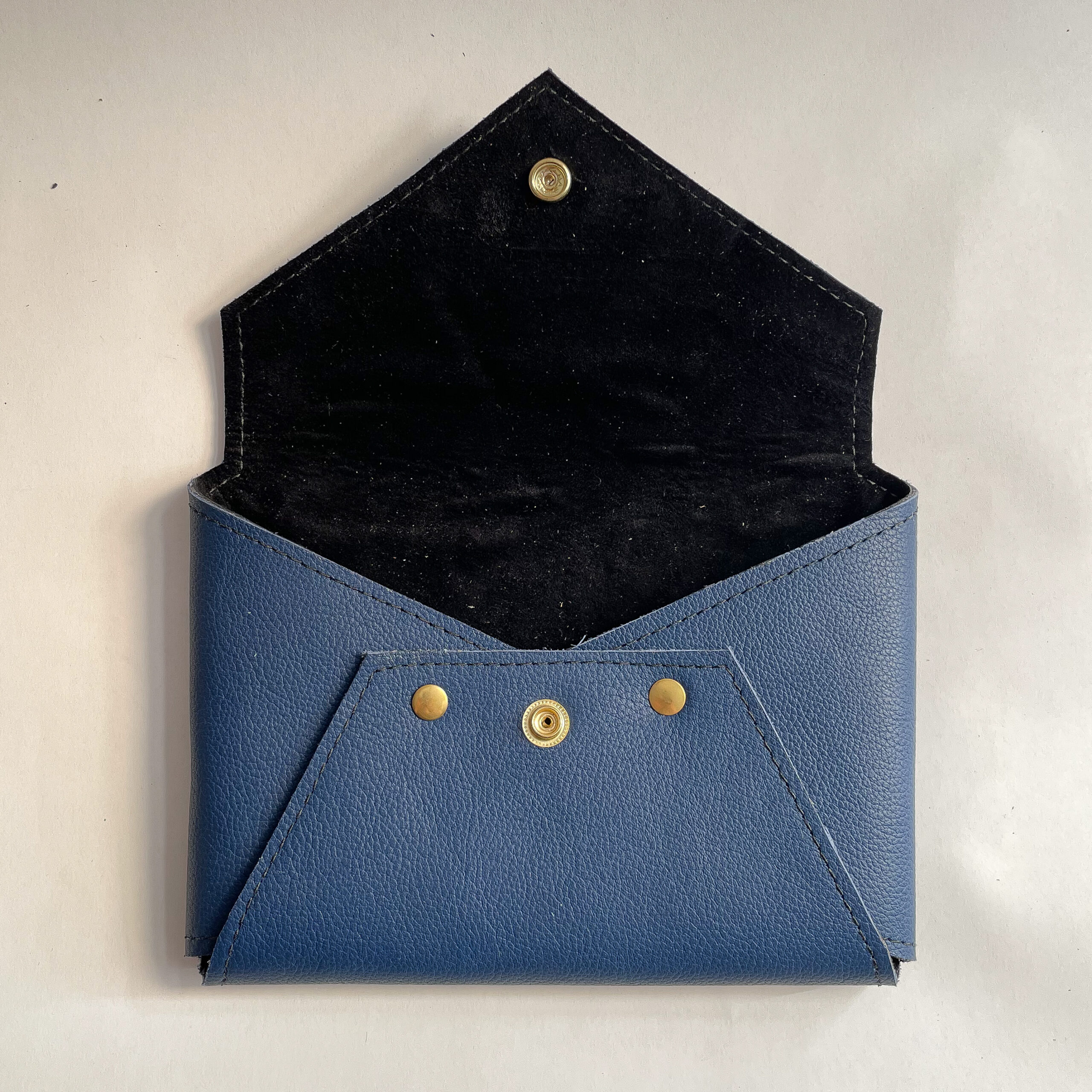 Open blue Envelope Clutch showing black lining