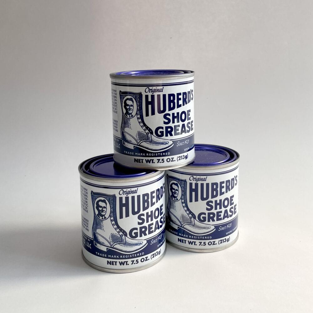 Three Huberd's Shoe Grease cans in a pyramid