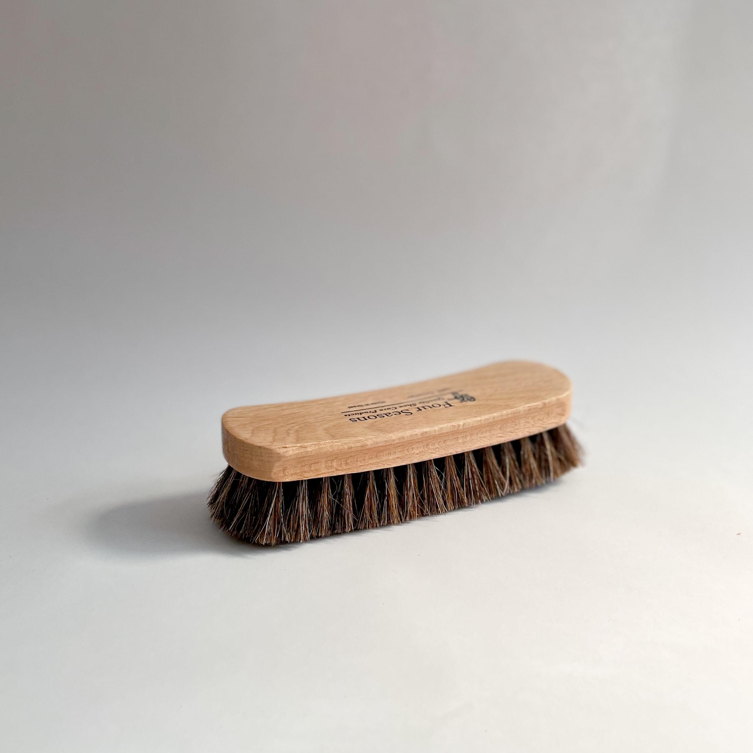 A single large buffing brush, bristles down